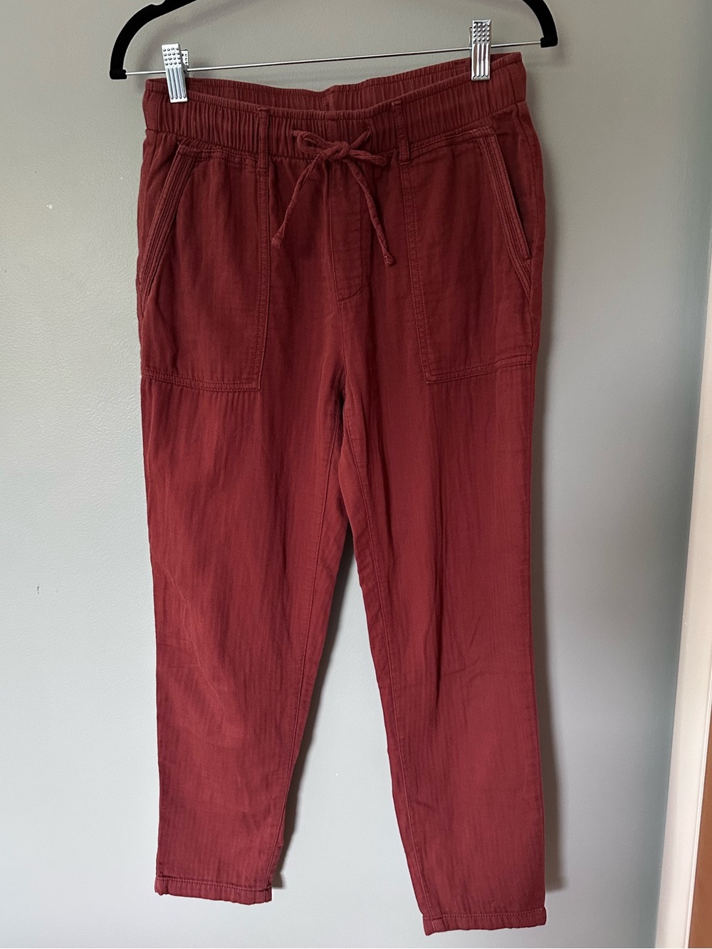 Burnt rust colored linen pants, tapered ankle